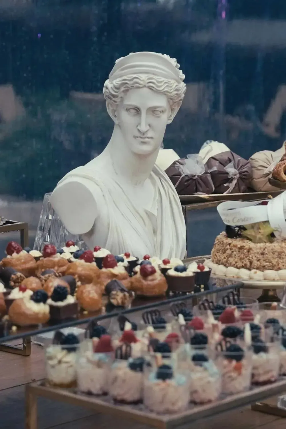 Dessert table with a classical bust, reception detail